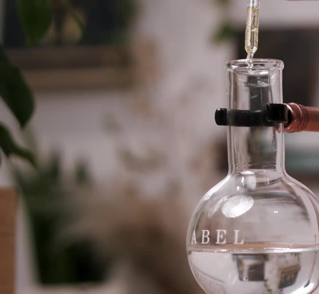 Fragrance oil being added to the water in an Abel flask