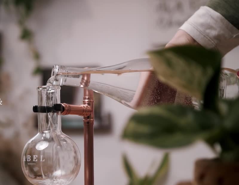 Water being poured into an original Abel burner flask